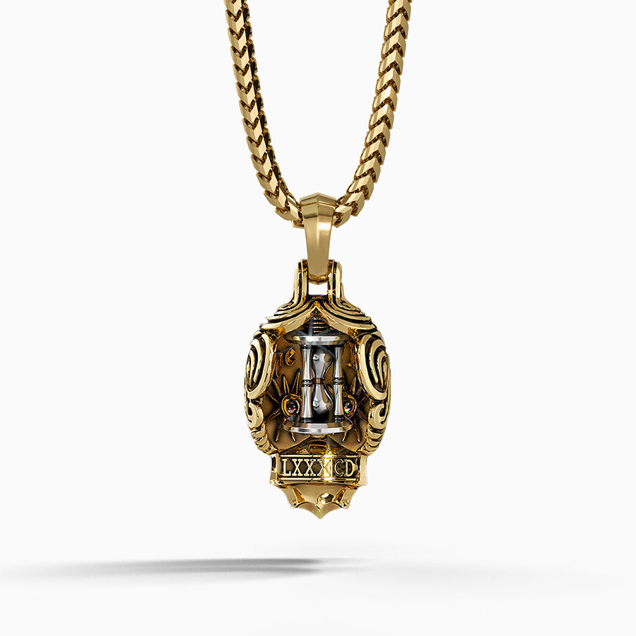 the back of a gold skull necklace features a spinning hourglass