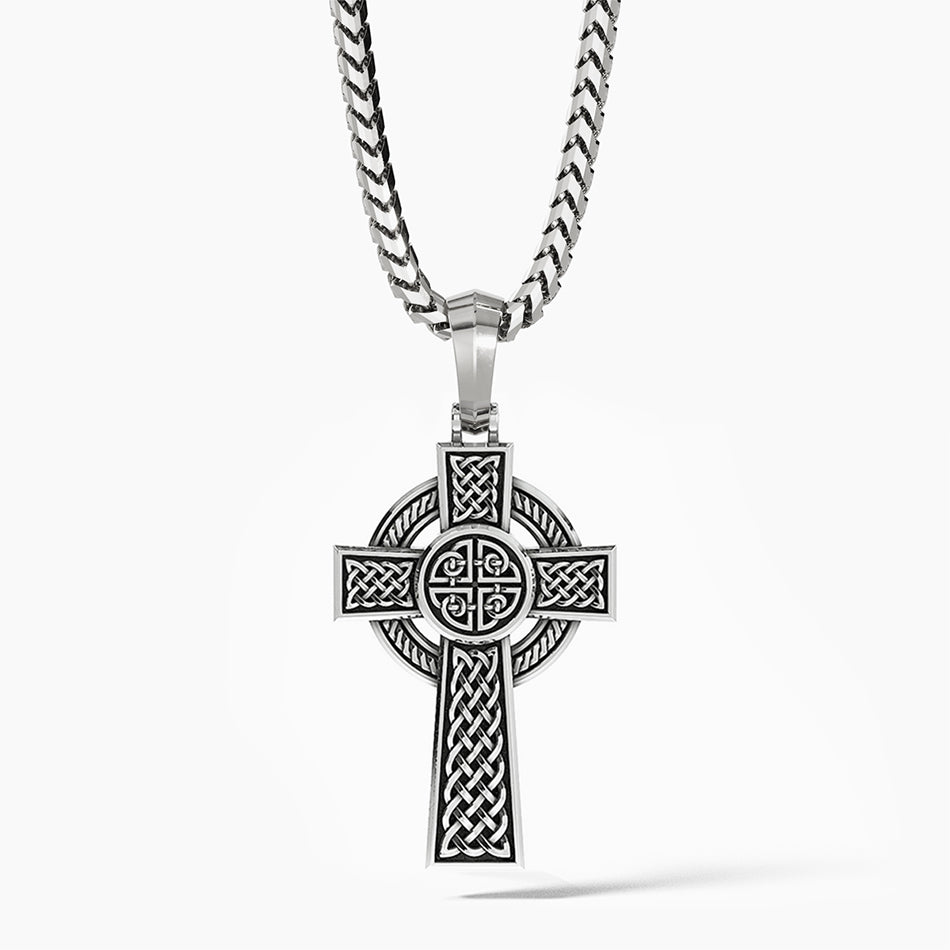 a Celtic cross hangs from a silver chain