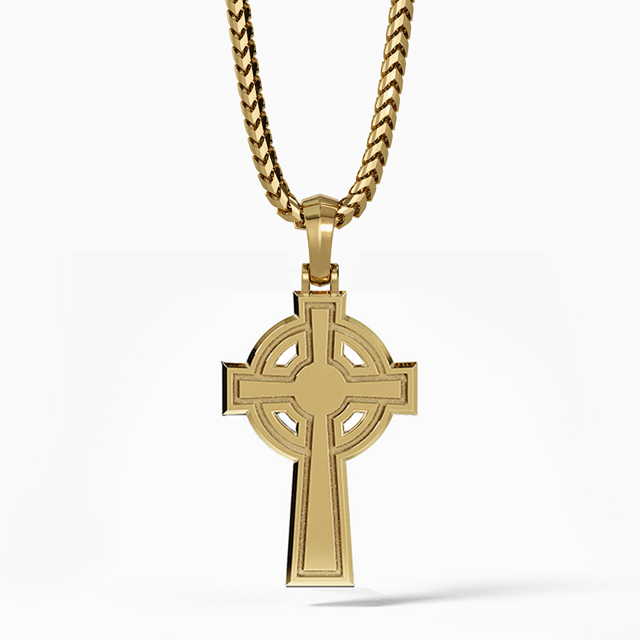 the back of a Celtic cross pendant shows a shining flat surface with simple engravings