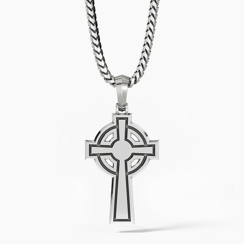 the back of a cross pendant shows a shining flat surface with simple engravings