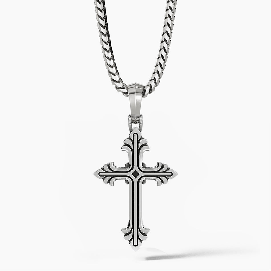 a sterling silver cross necklace hangs from a chain