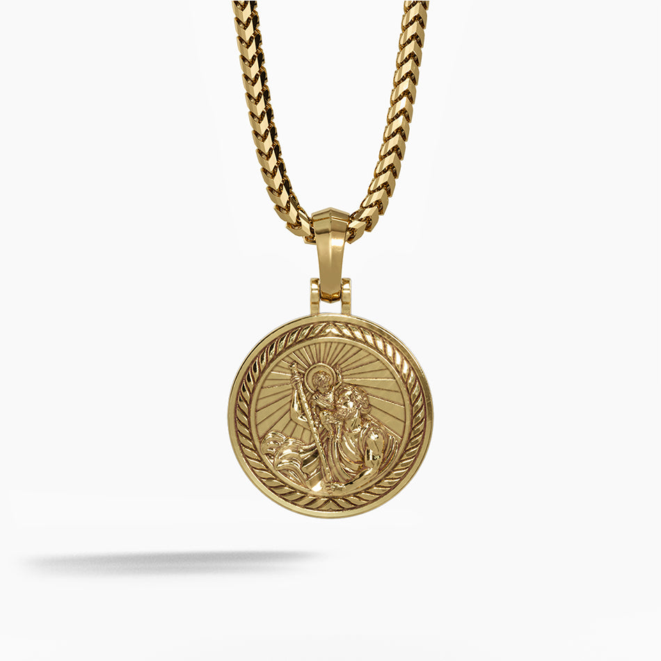 a round and polished gold Saint Christopher pendant with the sculpted saint carrying baby Jesus