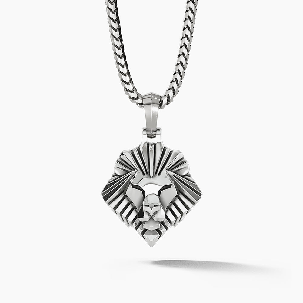 a simple silver lion head pendant hangs from a mens silver necklace