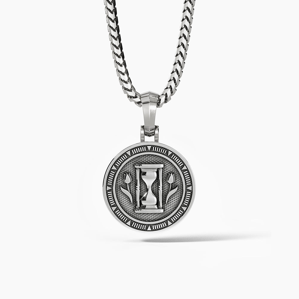 a polished silver medallion for men with the hourglass and two sculpted tulips