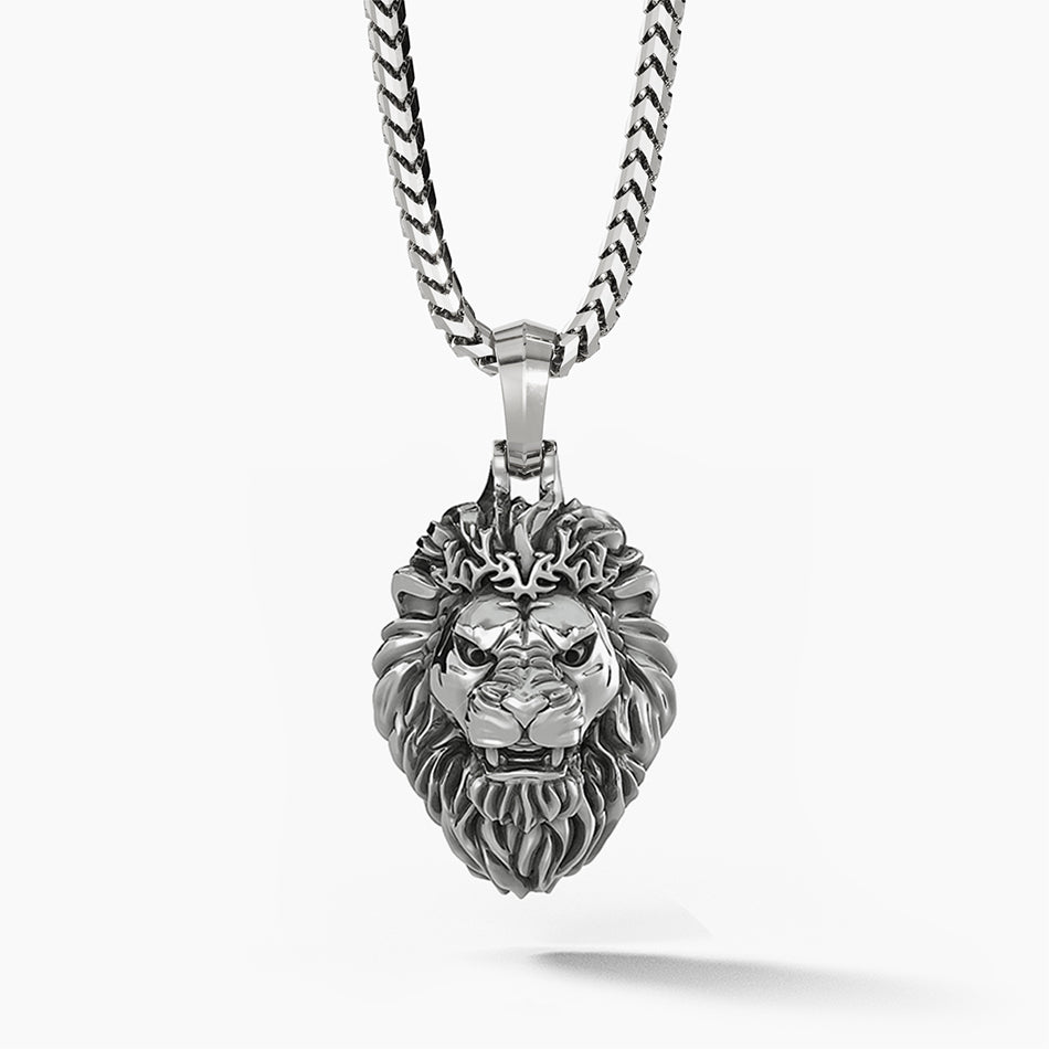 a fierce growling silver lion head pendant hangs from a silver necklace