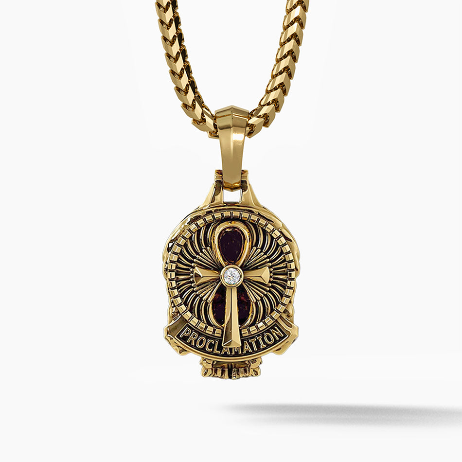 the back of a gold skull pendant features a ankh design with a diamond