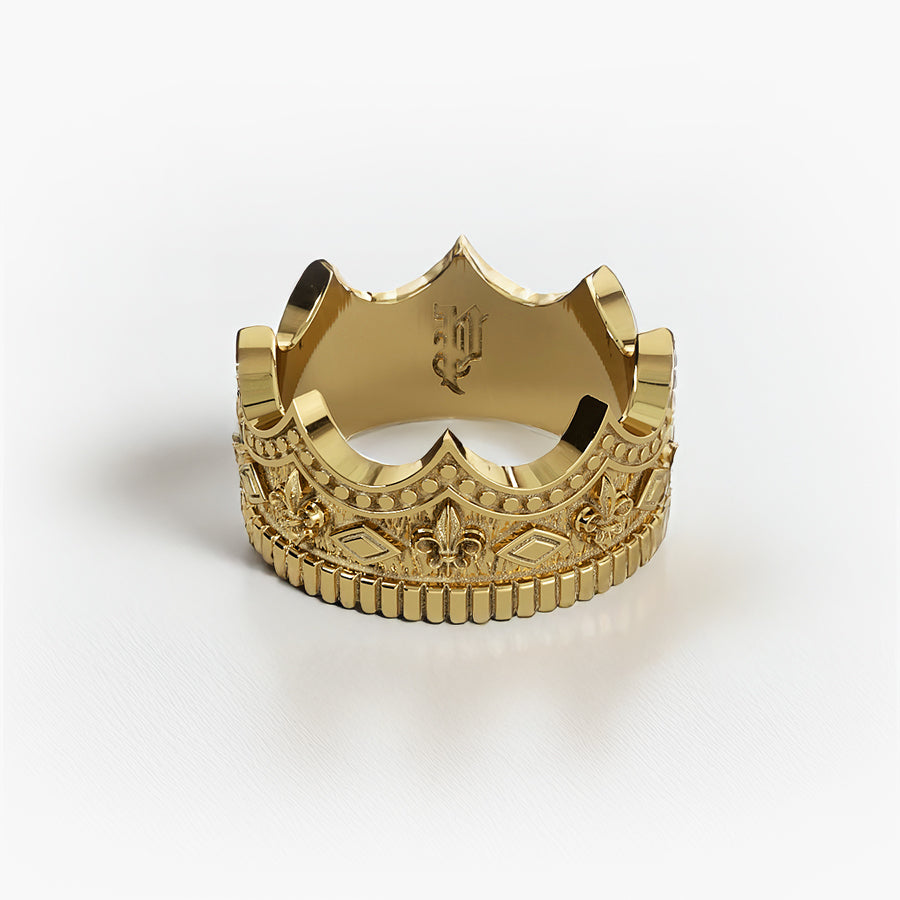 a gold crown ring with fleur-de-lis designs