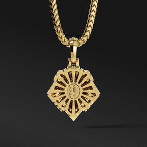 The back of a gold lion pendant features a sunburst pattern and the Proclamation Jewelry logo